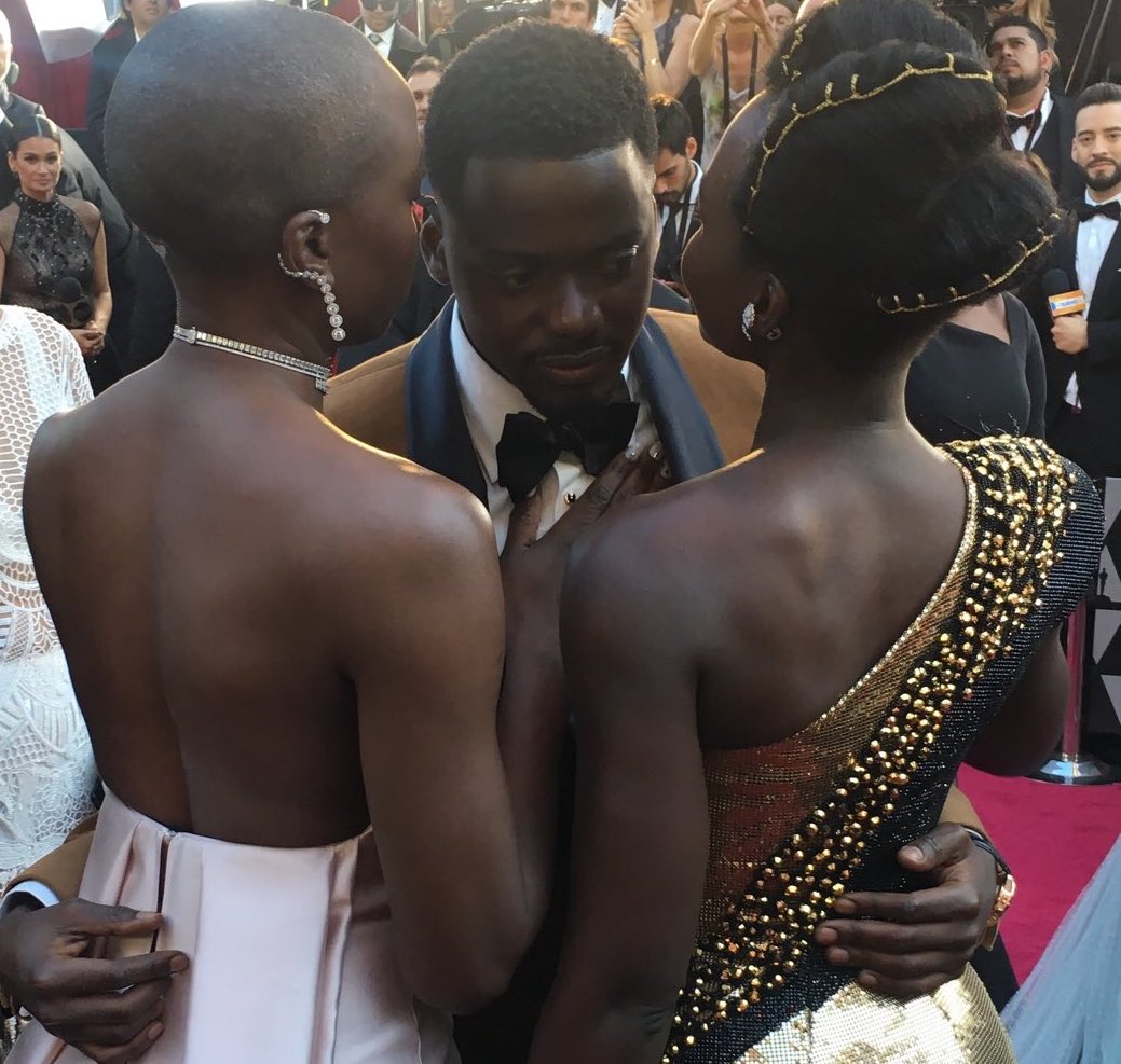 Daniel Kaluuya is embraced by Danai Gurira and Lupita Nyong'o on the red carpet.