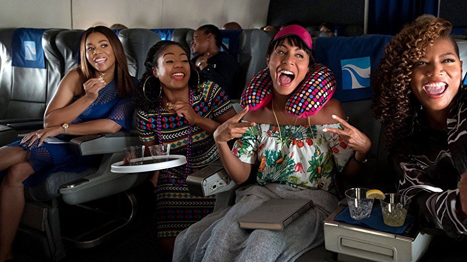 Regina Hall, Tiffany Haddish, Jada Pinkett Smith, and Queen Latifah have fun on an airplane in Girls Trip. 