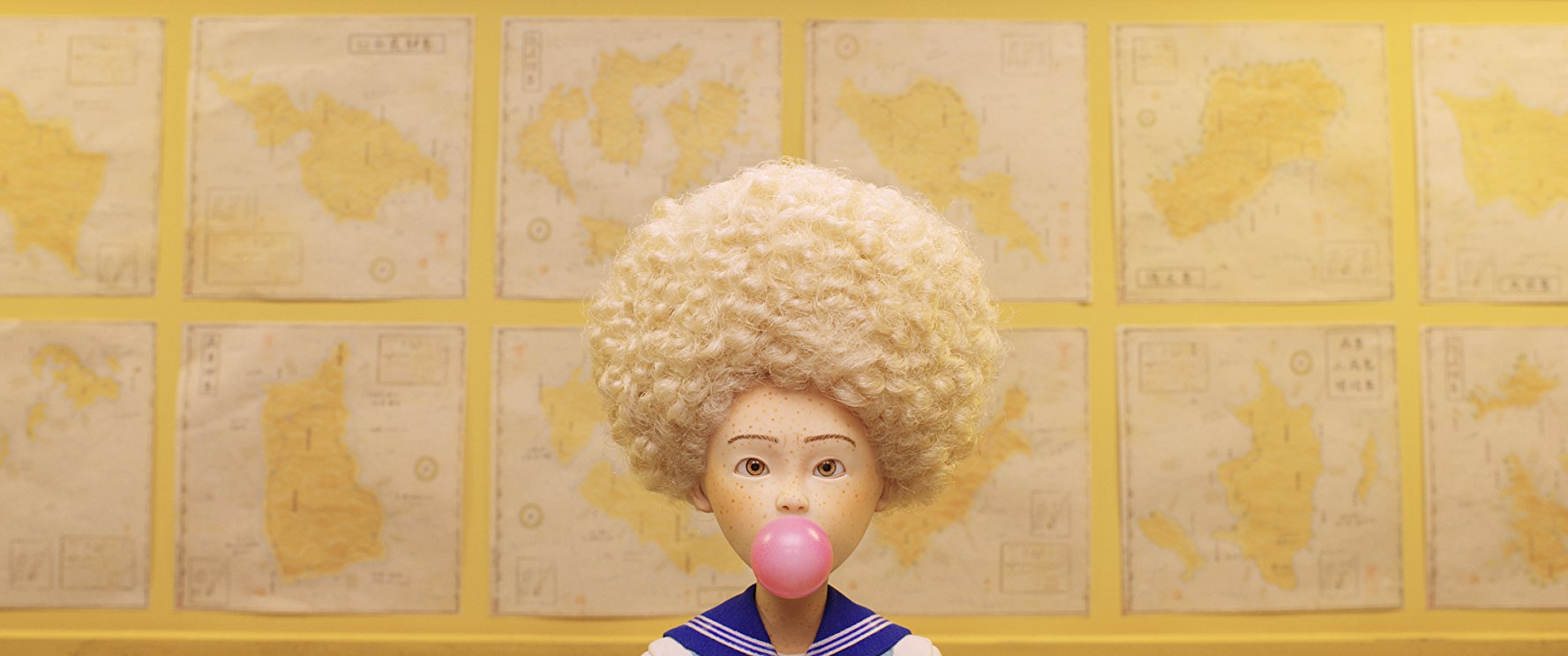 Tracy, voiced by Greta Gerwig, wears an afro and chews pink bubble gum.