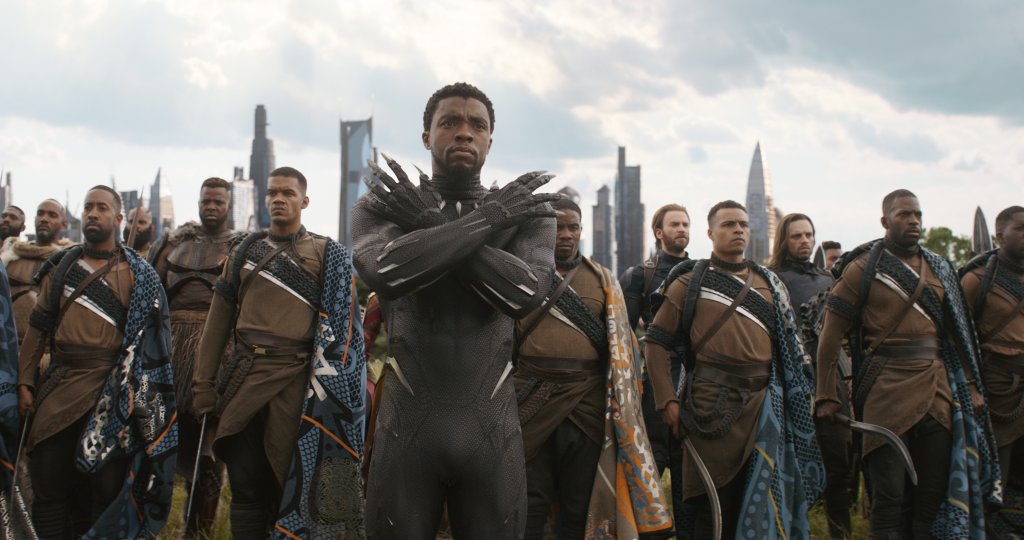 T'Challa in his Black Panther uniform stands with his army in Wakanda. 