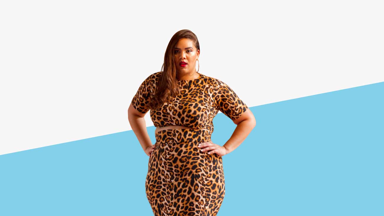 A Latina plus-sized model is wearing a leopard print two piece top and skirt set.