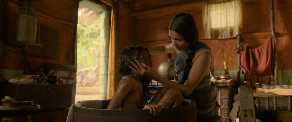 Rohan Chand as "Mowgli" and Freida Pinto as "Messua" in the Netflix film "Mowgli: Legend of the Jungle"