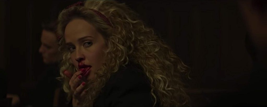 Siobhan Williams as Brandy Lynn. She licks the blood that's trailing from her nose. 