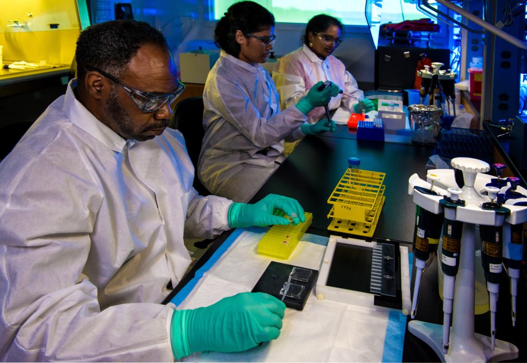 This photograph depicted Enteric Diseases Laboratory Branch (EDLB), Public Health scientists, as they were preparing enteric bacteria samples for “DNA fingerprinting”, using pulsed-field gel electrophoresis (PFGE). This picture was used to represent how scientists are preparing for a COVID-19 vaccine. 