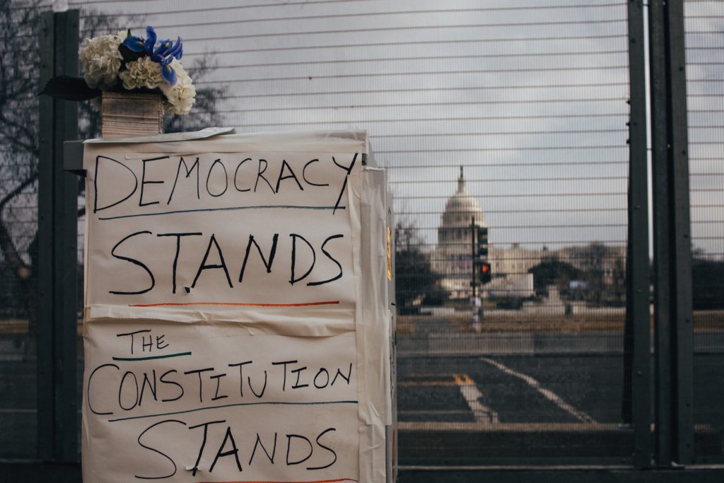 Sign in front of the Capitol Building, secured after January 6th insurrection. (Photo credit: Brendan Beale on Unsplash)