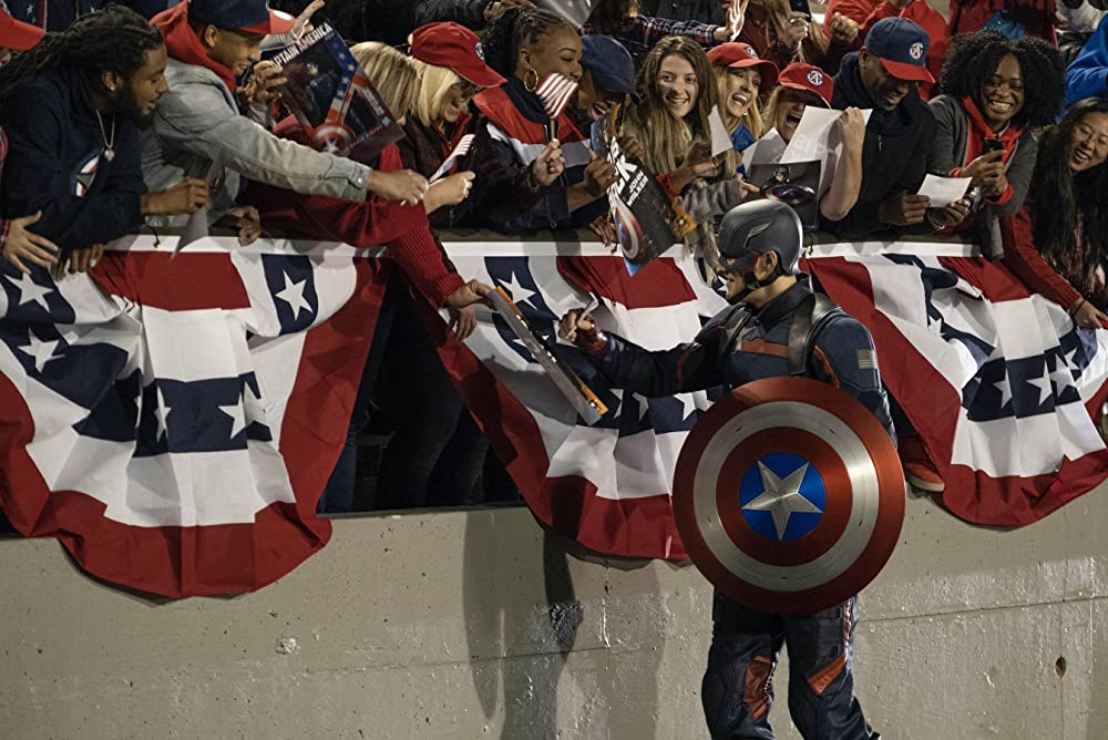 John Walker (Wyatt Russell) greeting the crowd as Captain America. (Disney+)