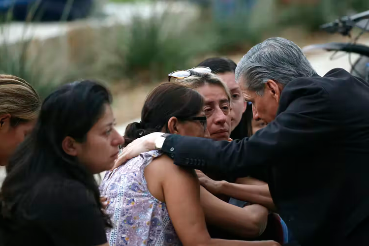 The archbishop of San Antonio, Gustavo Garcia-Siller, comforts families following a deadly school shooting at a school in Uvalde, Texas, on May 24, 2022.
