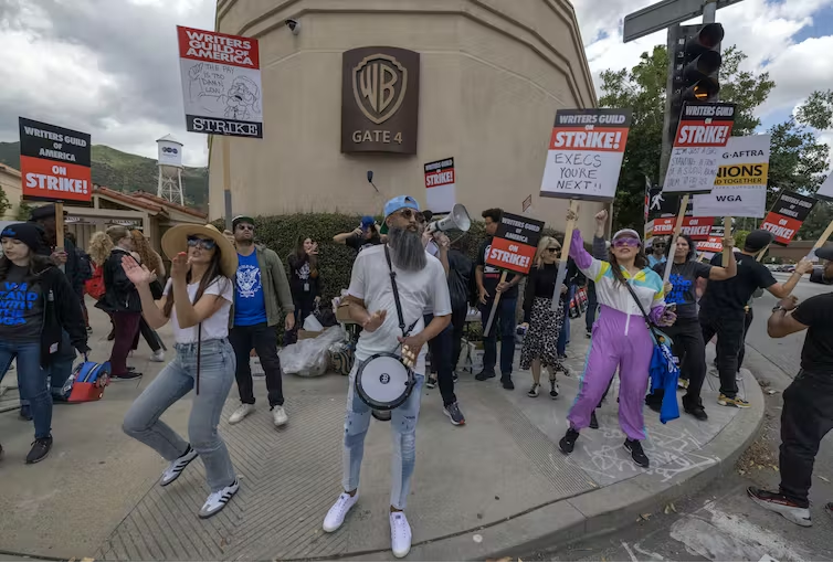 Striking workers picket outside of Warner Bros. Studios on the second day of the Hollywood writers strike on May 3, 2023, in Burbank, Calif. (David McNew/Getty Images)